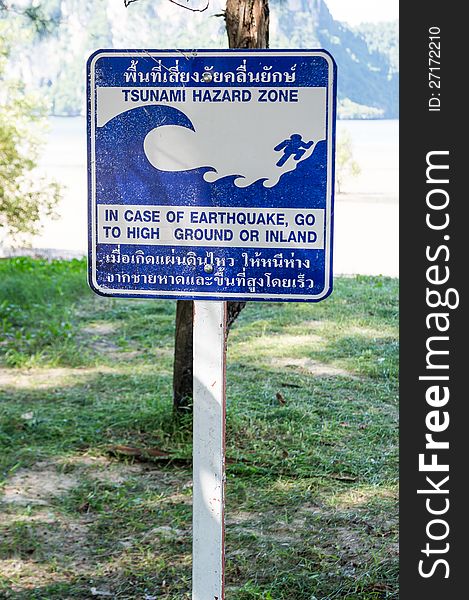 Blue tsunami hazard zone warning sign on the beach. Blue tsunami hazard zone warning sign on the beach