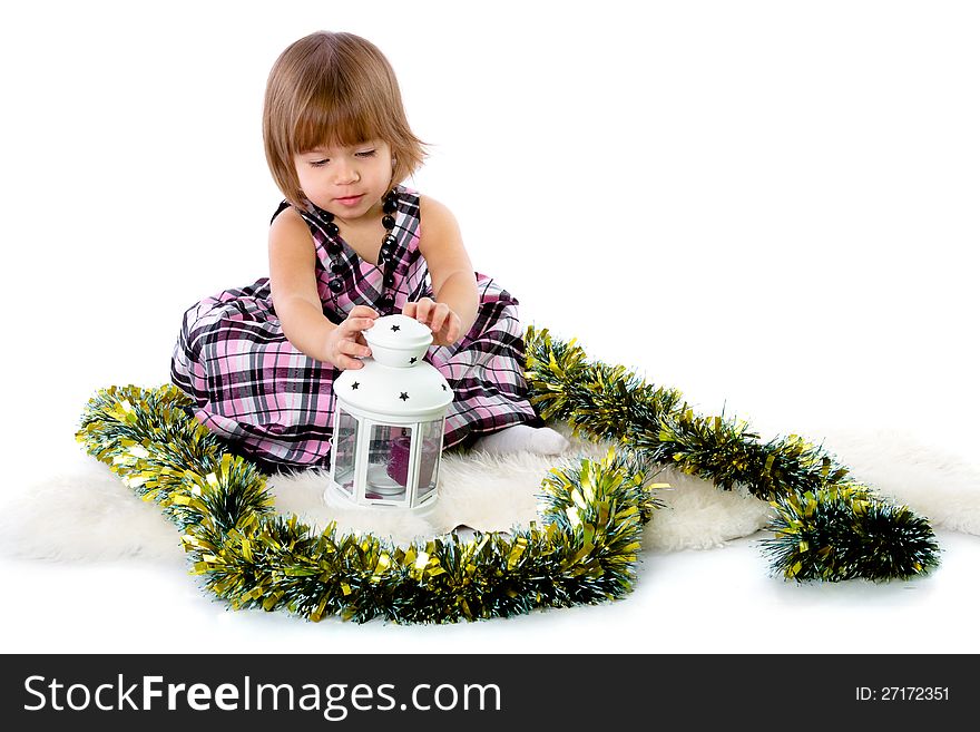 Little girl playing with baubles. on white background