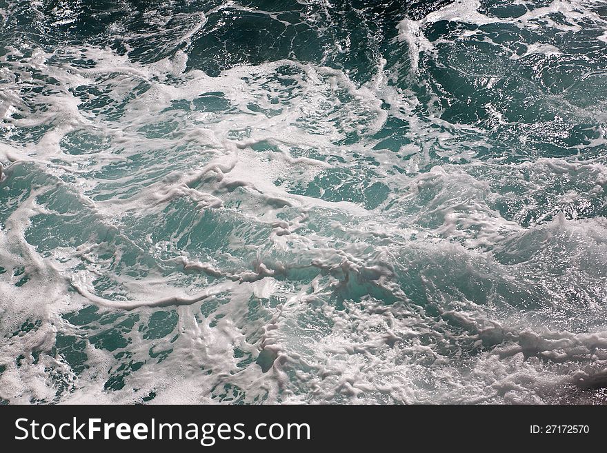 Splash of seawater with waves and sea foam. Splash of seawater with waves and sea foam