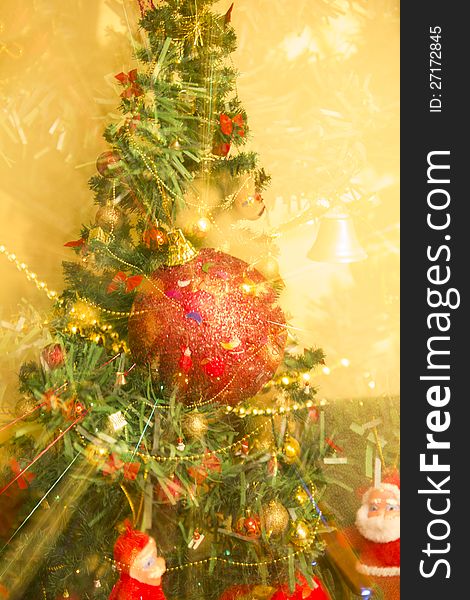 Abstract Christmas tree and decorations on a yellow background