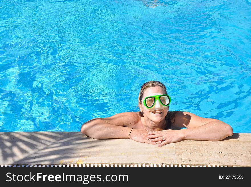 Beautiful woman in a swimming pool, wearing a mask