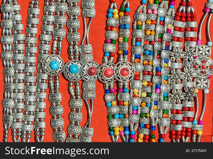 Silver with colorful decorative stone bracelet of hill tribe in northern of thailand on red background.