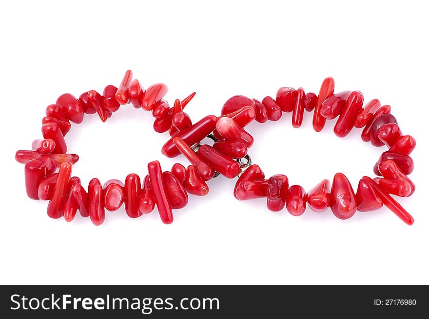 Natural coral bracelet laid out as infinity symbol, on white background. Natural coral bracelet laid out as infinity symbol, on white background.