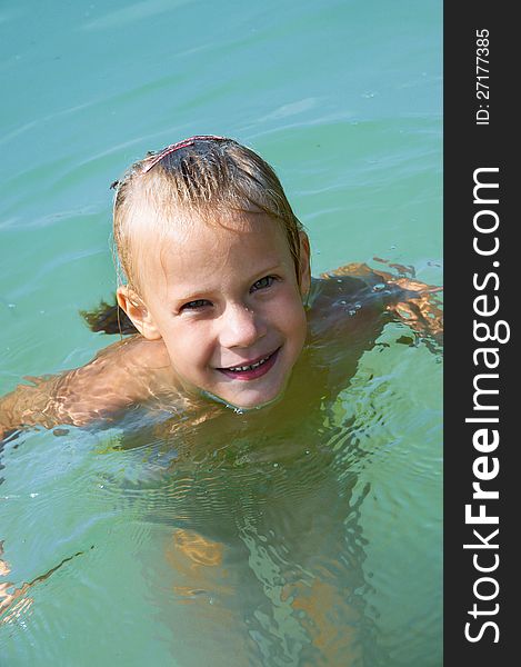 Little girl swimming in lake outdoors. Little girl swimming in lake outdoors