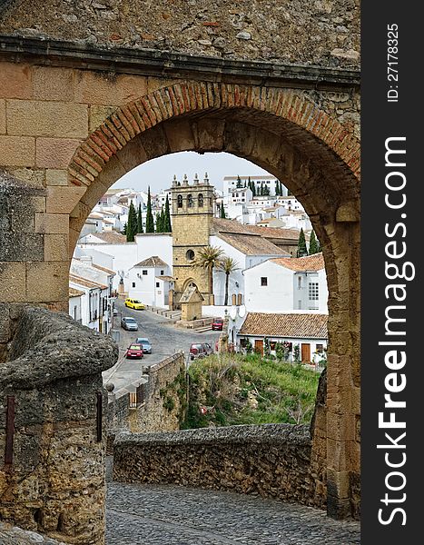 Ronda is the most well-known of white towns on the south coast of Spain. It is photographed through the stone arch of the ancient Arab bridge (Puente Viejo). Ronda is the most well-known of white towns on the south coast of Spain. It is photographed through the stone arch of the ancient Arab bridge (Puente Viejo).