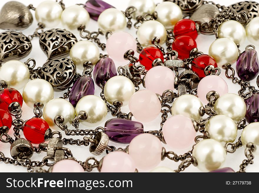 Background of vintage beaded necklace with stones and pearls. Background of vintage beaded necklace with stones and pearls.