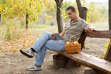Man On Rustic Bench Reading A Book Royalty Free Stock Photo