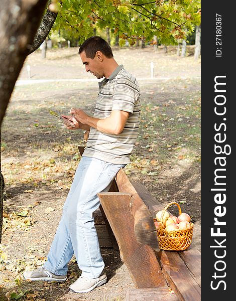 Man using a tablet in woodland. Man using a tablet in woodland