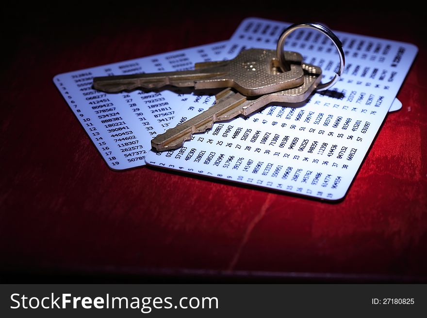 Security concept. Two keys lying on plastic cards with digits. Security concept. Two keys lying on plastic cards with digits