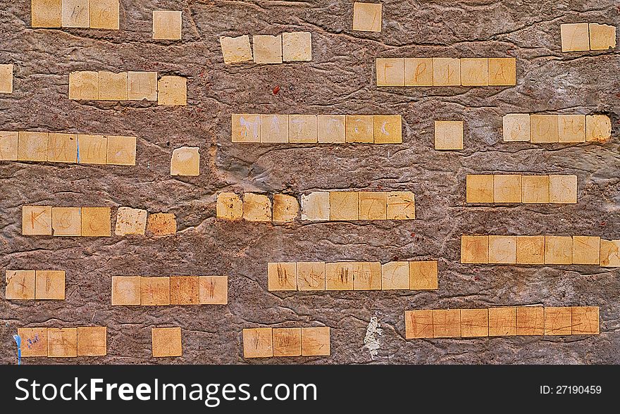 Concrete wall background or texture with ceramic pieces