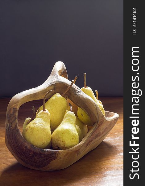 Juicy pears in a wooden bowl, natural light. Juicy pears in a wooden bowl, natural light