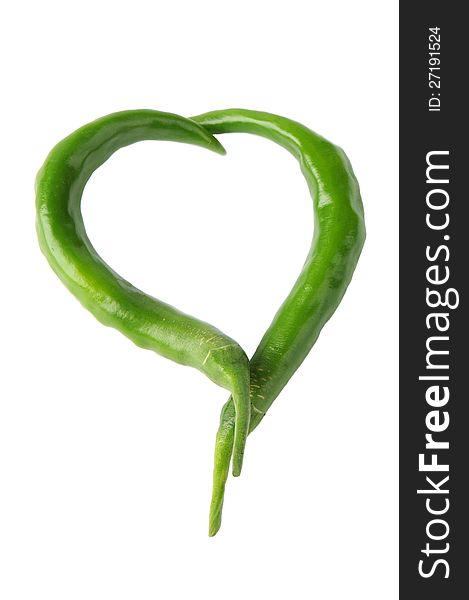 Two green peppers in a heart shape on a white