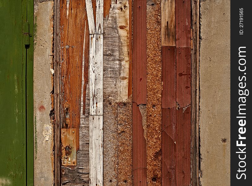 Aged damaged door made of various wooden materials