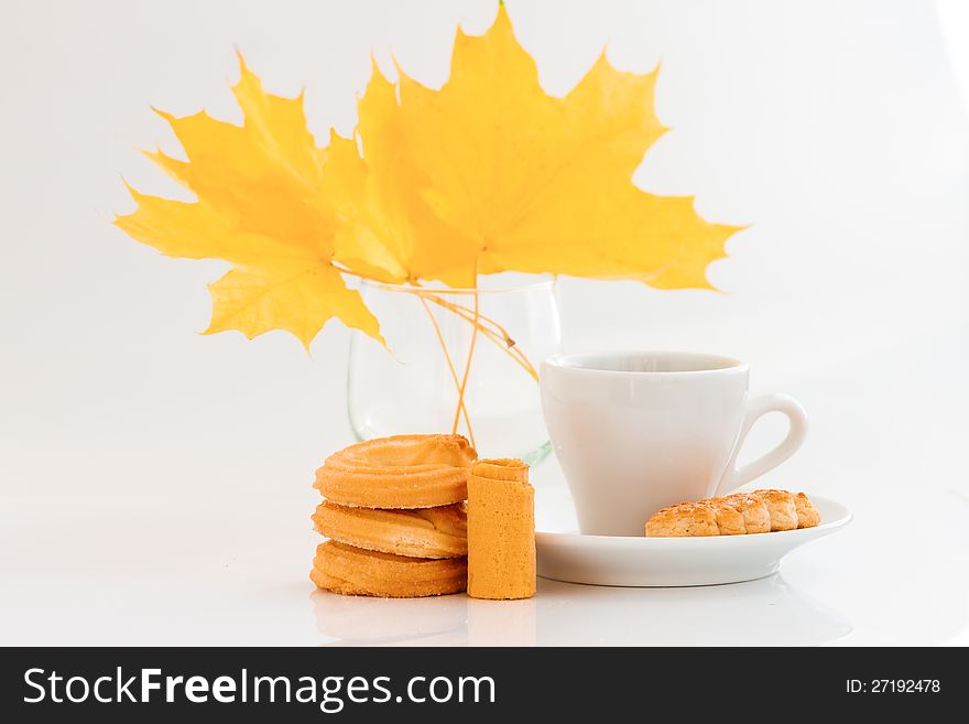 Coffee cup with cookies and autumn leaves on white background. Coffee cup with cookies and autumn leaves on white background