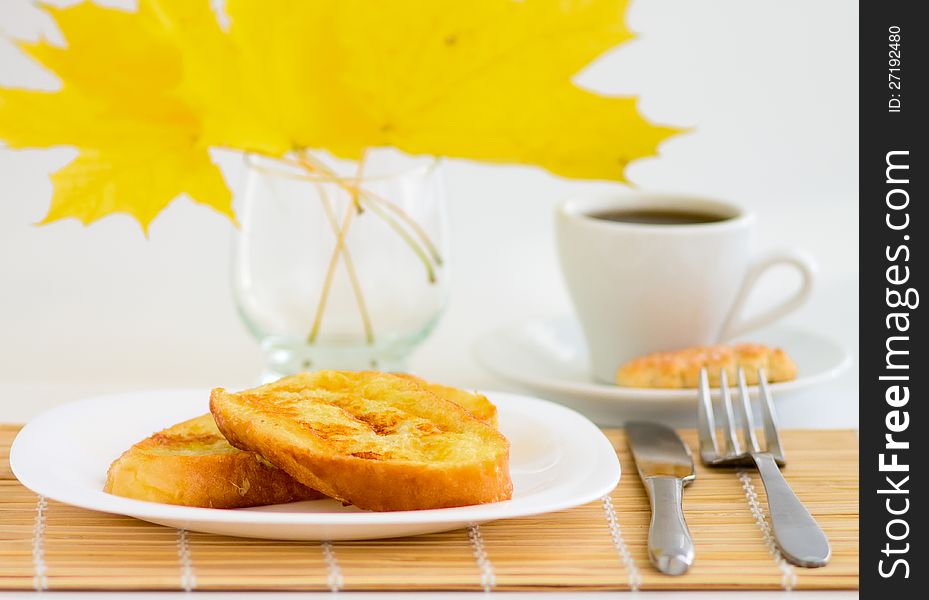 Cup of coffee and sweet toast on bamboo table