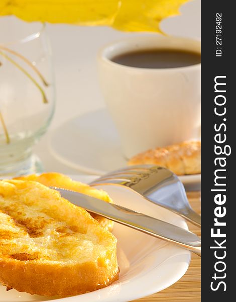 Coffee cup and sweet toast with autumn leaves on white background