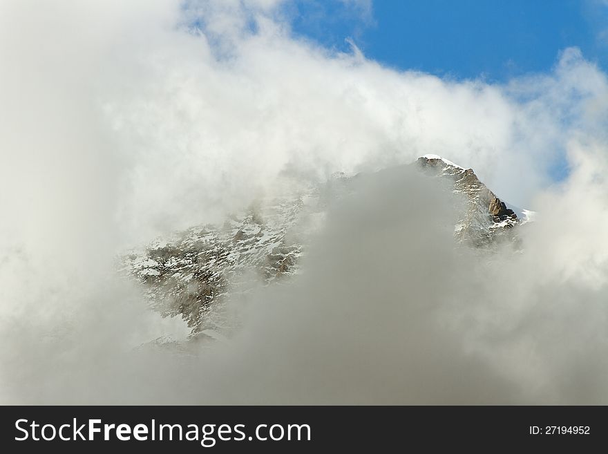 Big clouds above high mountain.