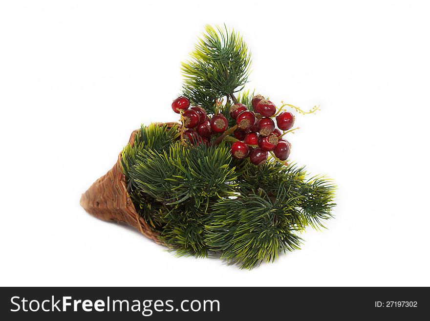 Christmas arrangement made with pine branches and red berries (synthetic materials)