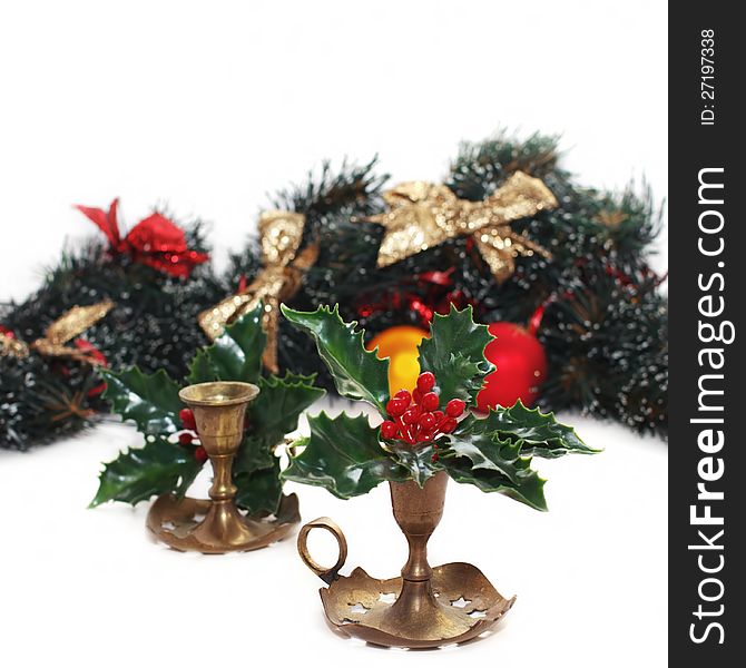 Christmas arrangement with vintage candlesticks and red berries,  on white