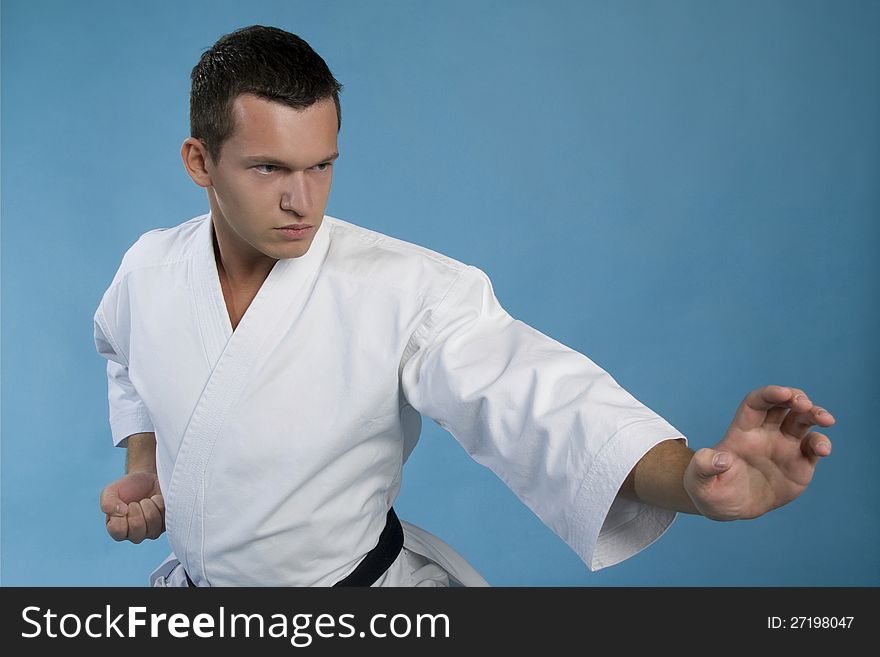 Young man practice karate kata in studio