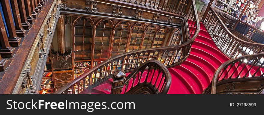 Red butterfly staircase with oakwood handrail, from side