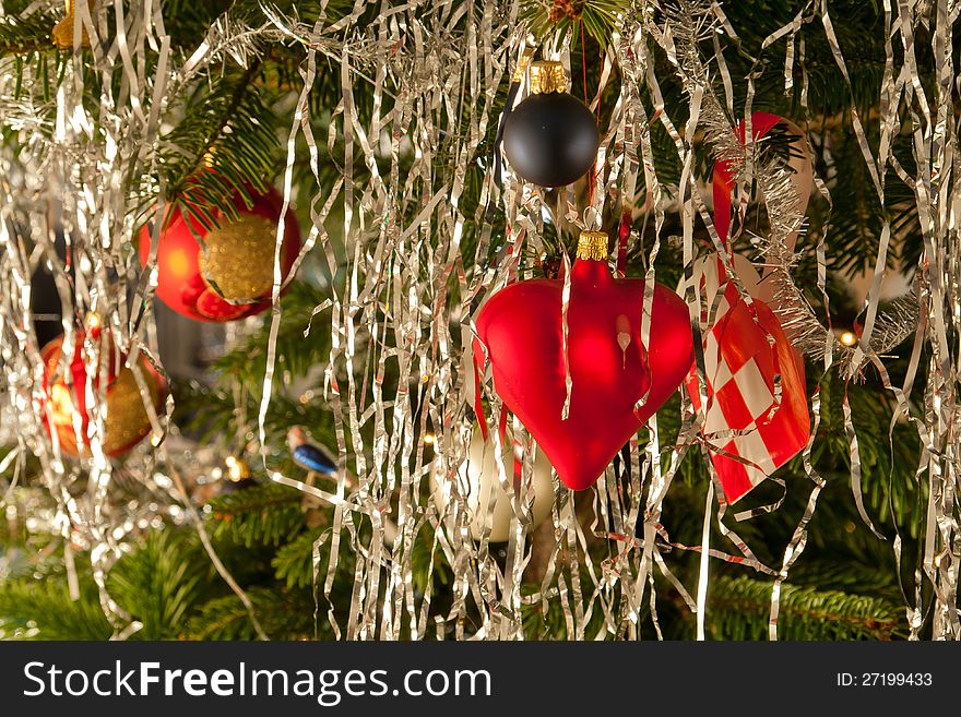 Christmas decoration red golden balls and hearts on a beautiful festive tree. Christmas decoration red golden balls and hearts on a beautiful festive tree