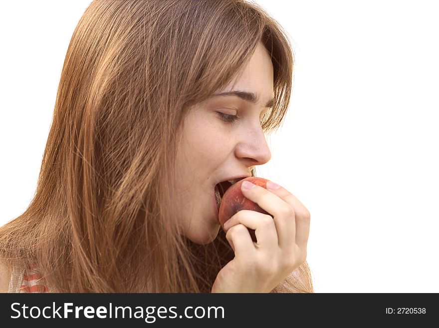 Young girl eating juicy peach