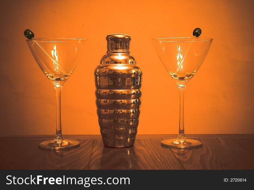 Martini Shaker and glasses against an orange background