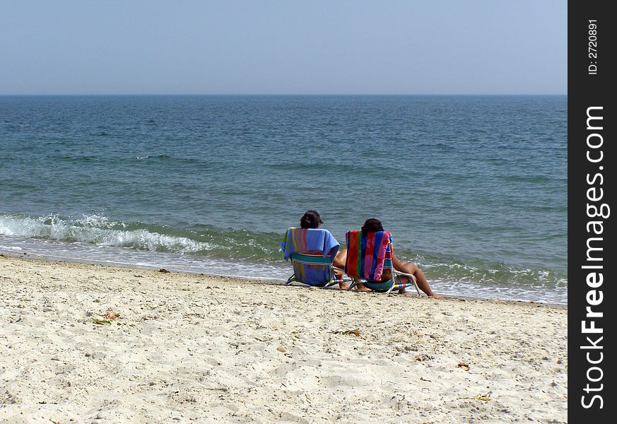 Two women getting a suntan at the beach. Two women getting a suntan at the beach
