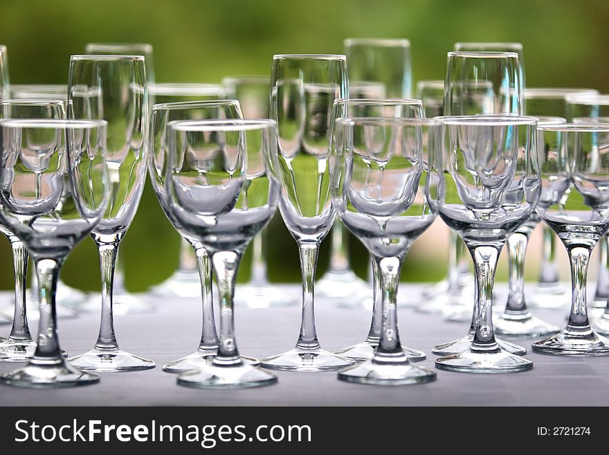 Different glass in row on blurred background. Different glass in row on blurred background