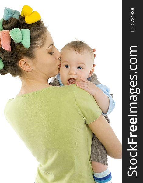 Young, beautiful woman with baby on hands. Hugging baby and kissing. Looking at camera, white background. Young, beautiful woman with baby on hands. Hugging baby and kissing. Looking at camera, white background