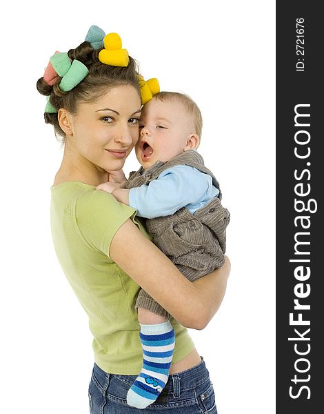 Young, beautiful woman with baby on hands. Hugging baby and smiling. Baby is yawn. Looking at camera, white background. Young, beautiful woman with baby on hands. Hugging baby and smiling. Baby is yawn. Looking at camera, white background