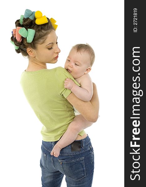 Young, beautiful woman with baby on hands. Baby is biting mother's arm. Mother is looking at baby. White background. Young, beautiful woman with baby on hands. Baby is biting mother's arm. Mother is looking at baby. White background