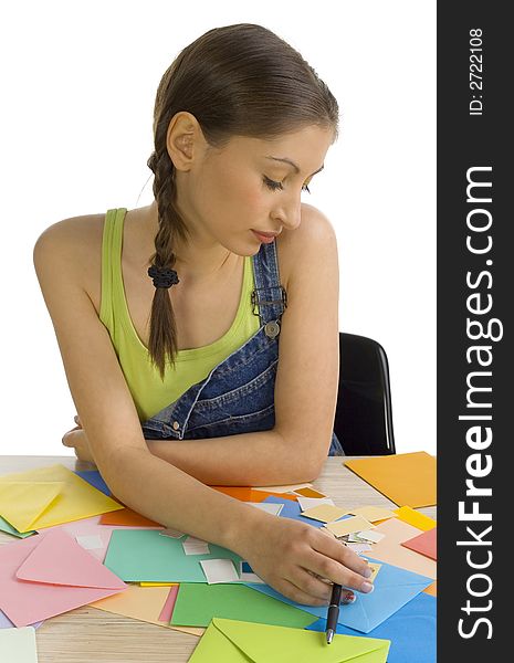 Young, beautiful, sad woman sitting and writing a letter. Thinking of something, front view. White background. Young, beautiful, sad woman sitting and writing a letter. Thinking of something, front view. White background