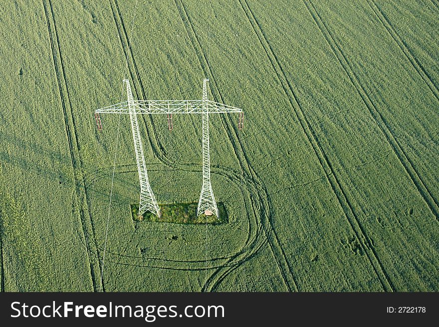 Air view of a high voltage pole in the green field