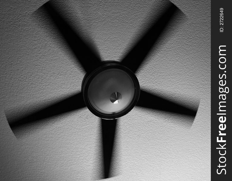 A black and white photo of a modern-style fan. The motion of the fan has blurred the image somewhat. A black and white photo of a modern-style fan. The motion of the fan has blurred the image somewhat.