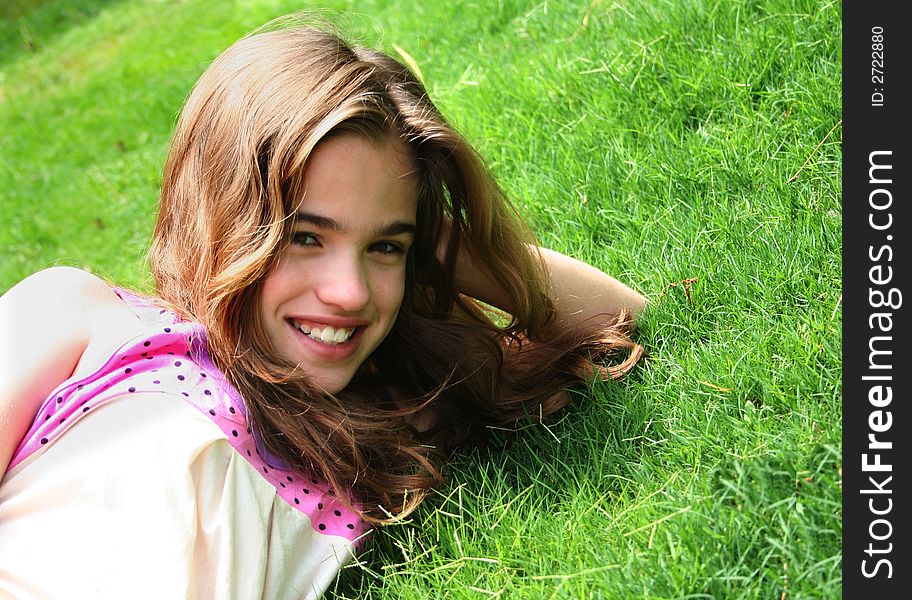 Smiling young girl on fresh green grass. Smiling young girl on fresh green grass