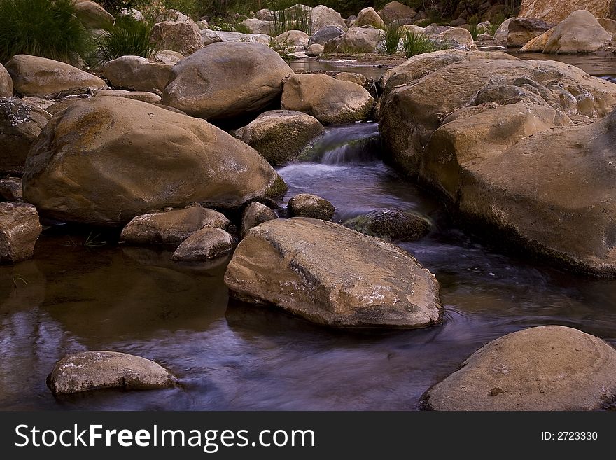 Flowing stream surrounded by beautiful boulders