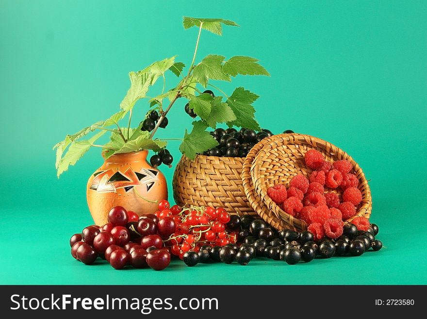 Berries of a red currant, a black currant, a raspberry and a cherry in a basket. Berries of a red currant, a black currant, a raspberry and a cherry in a basket.