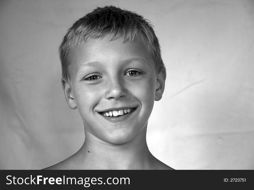 Portrait of young boy smiling in black and white