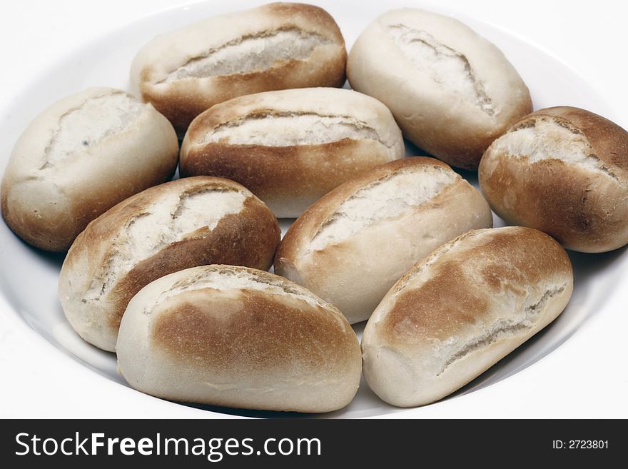 A stack of freshly baked white bread rolls on white