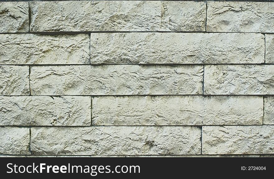 A structure of a wall from an artificial grey stone; the good background creating sensation of hardness and reliability. A structure of a wall from an artificial grey stone; the good background creating sensation of hardness and reliability.