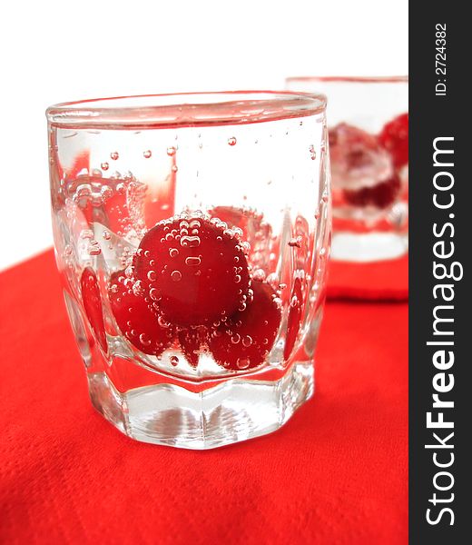 Cherry in glass of mineral water. Cherry in glass of mineral water