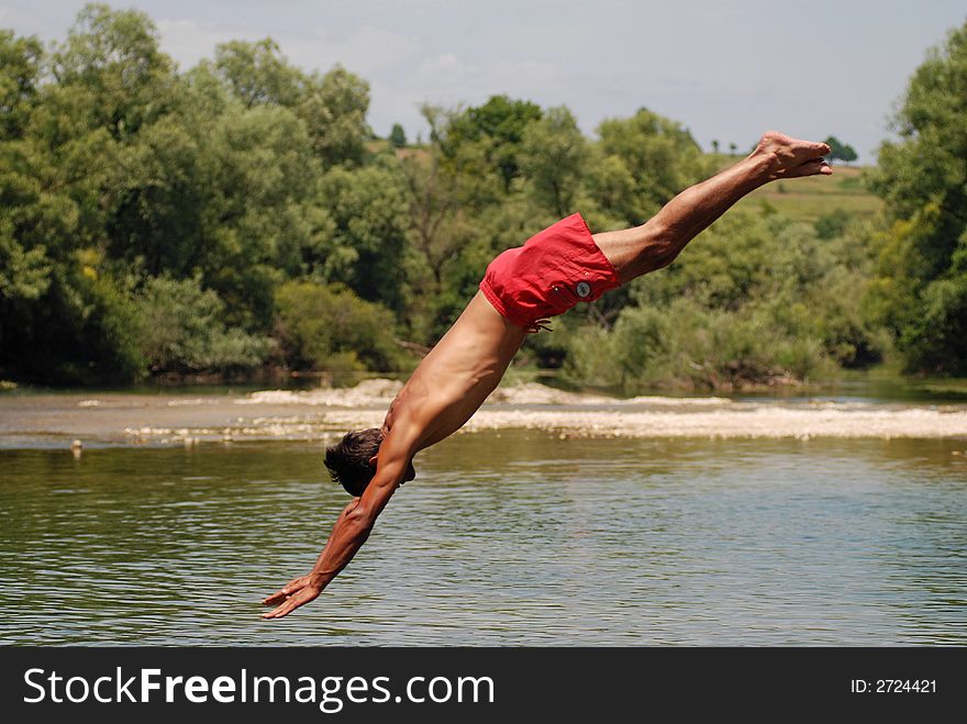 Man jumping in green river. Man jumping in green river