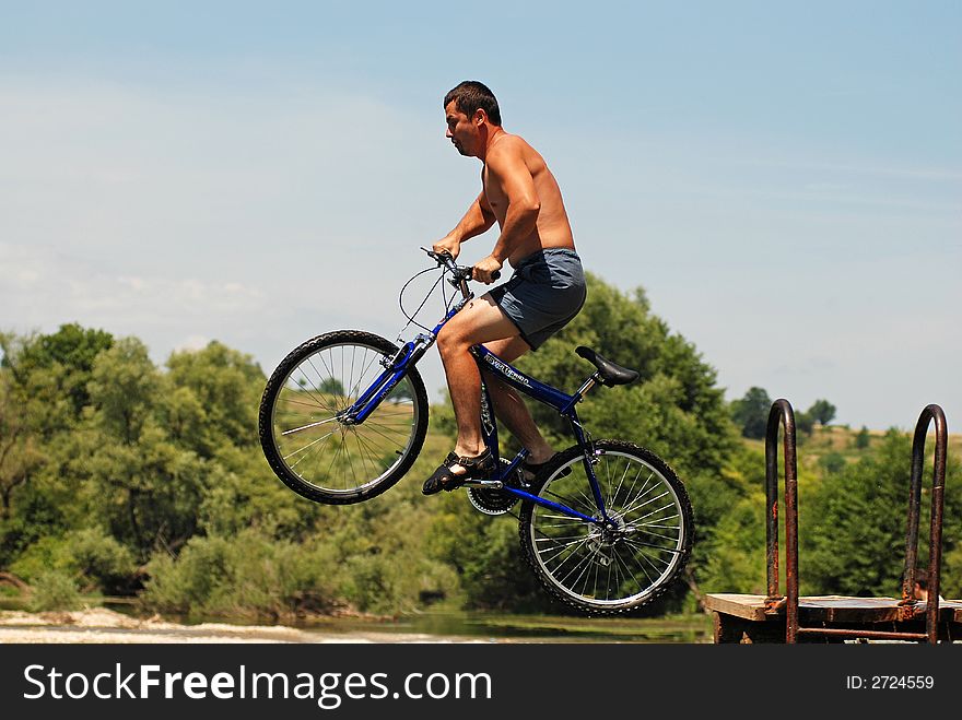 Young man bathing with bike
