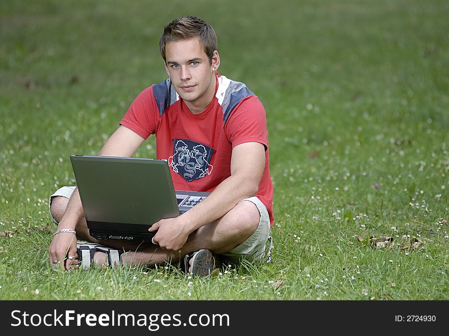 Picture of young man with notebook in park