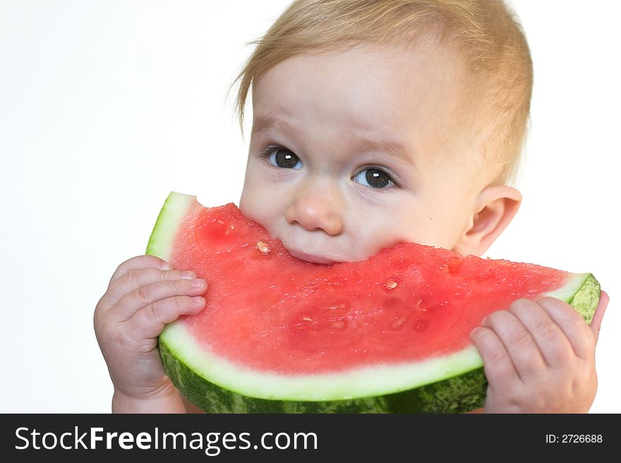 Image of cute toddler eating a big piece of watermelon. Image of cute toddler eating a big piece of watermelon