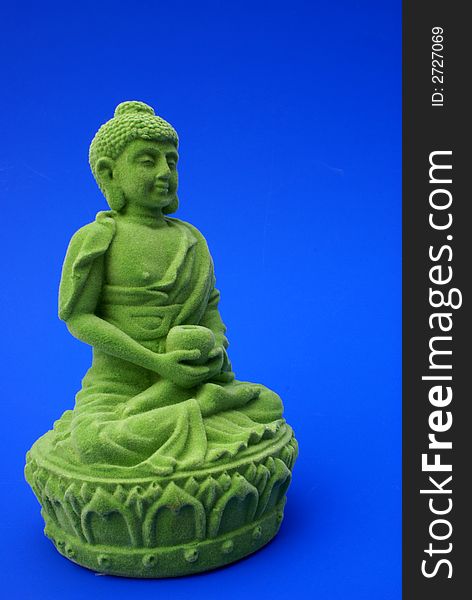 Green buddha against blue background. Green buddha against blue background.