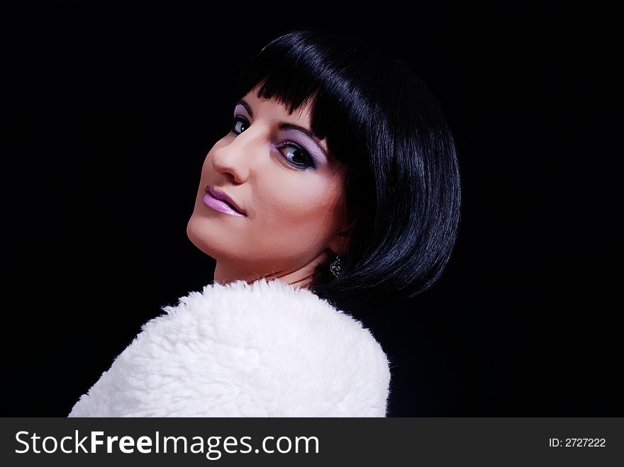 Young woman leaning back looking a the camera wearing white fur. Young woman leaning back looking a the camera wearing white fur