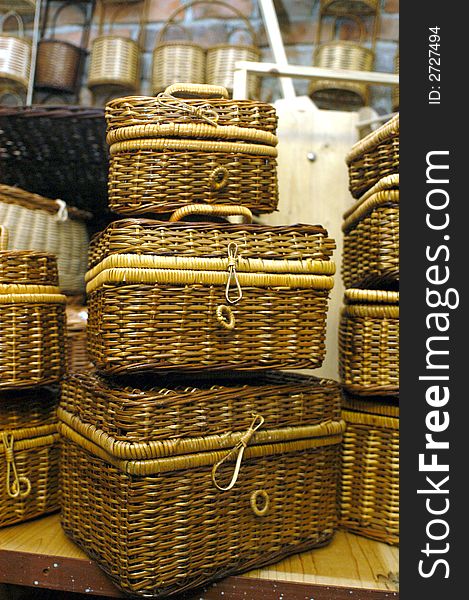 Three wickerwork baskets on a shelf in a shop